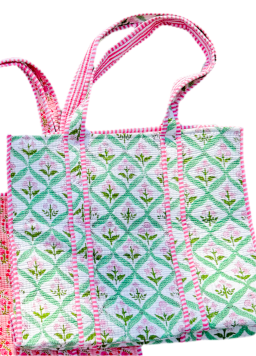 Fabric bag with pink and green pattern on a white background
