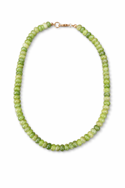 Green beaded necklace on a white background
