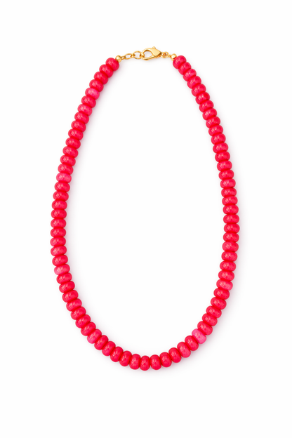 Pink beaded necklace on a white background