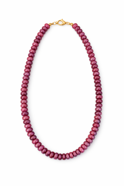 Red beaded necklace with a gold clasp on a white background