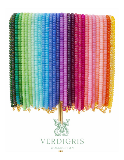Colorful beaded fan with 'Verdigris' branding on a white background
