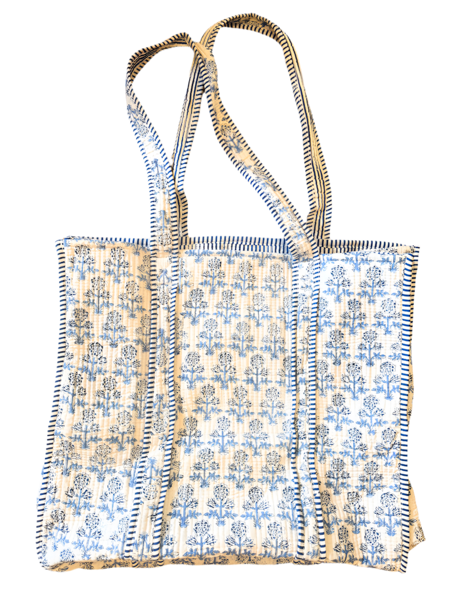 Floral patterned tote bag with striped handles on a white background